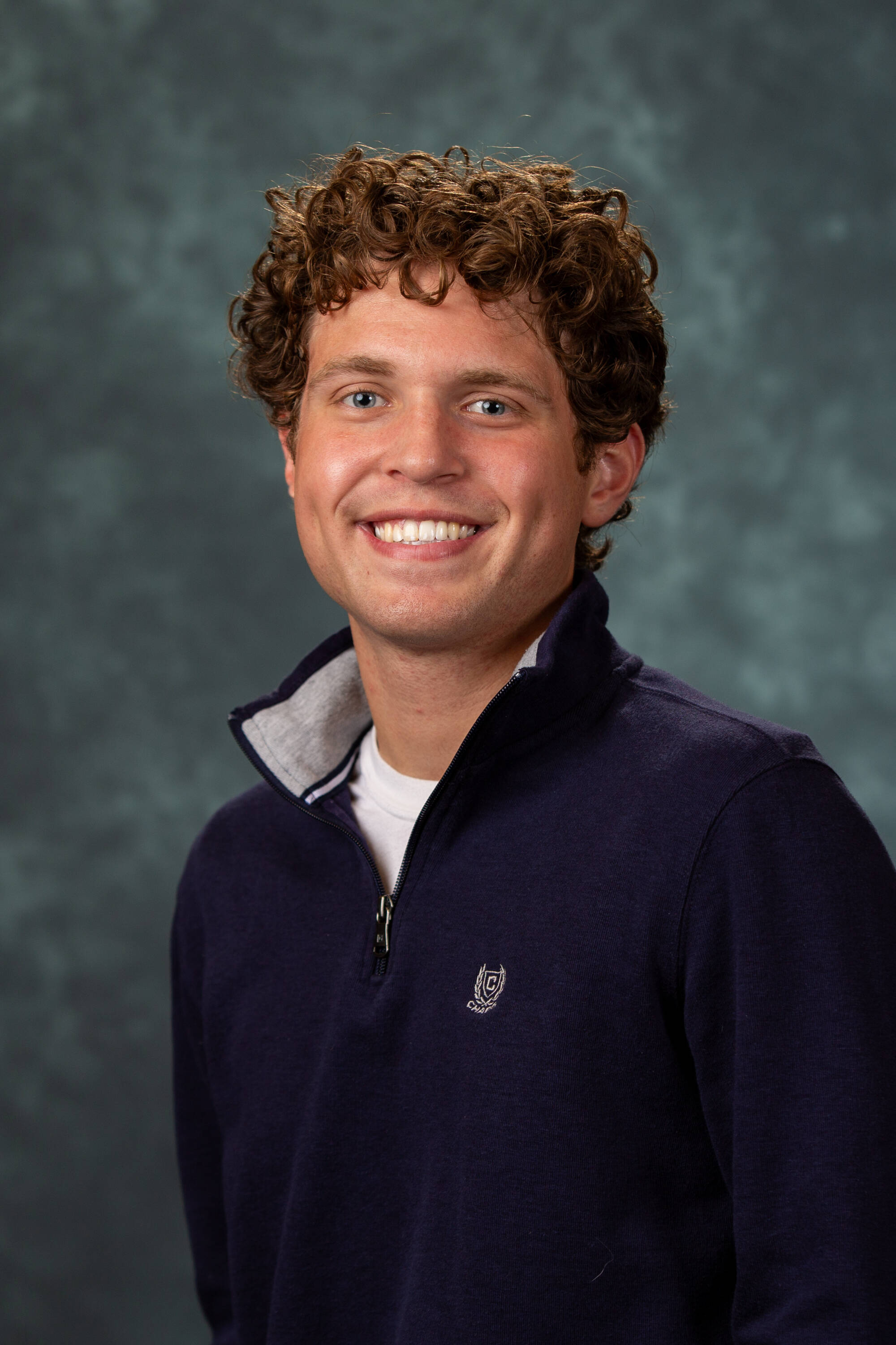 Ty Vanlerberghe smiling in a blue quarter-zip.